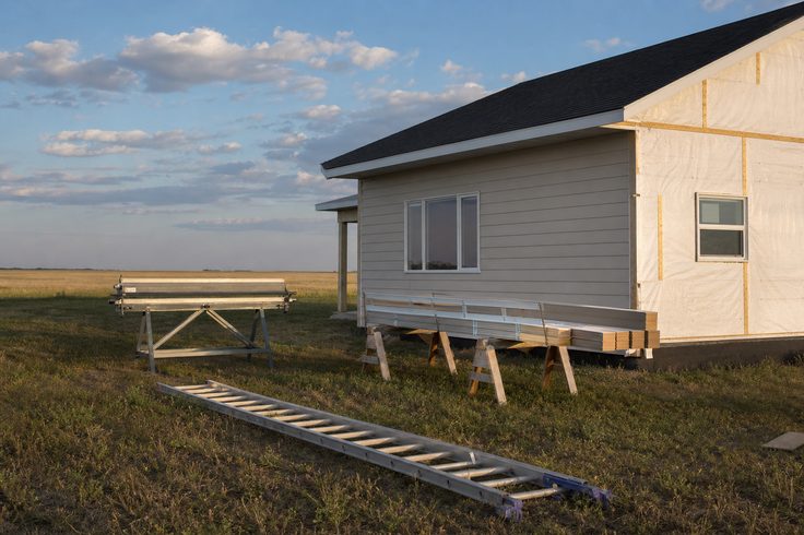 Partially sided Saskatoon home showing house wrap and new horizontal siding courses